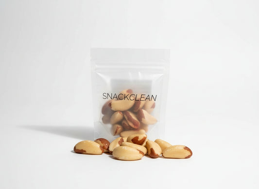 Clear bag of brazil nuts with 'SNACKCLEAN' branding on a white background