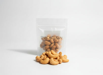 Clear 'SNACKCLEAN' bag with cashews spilling out on a white background